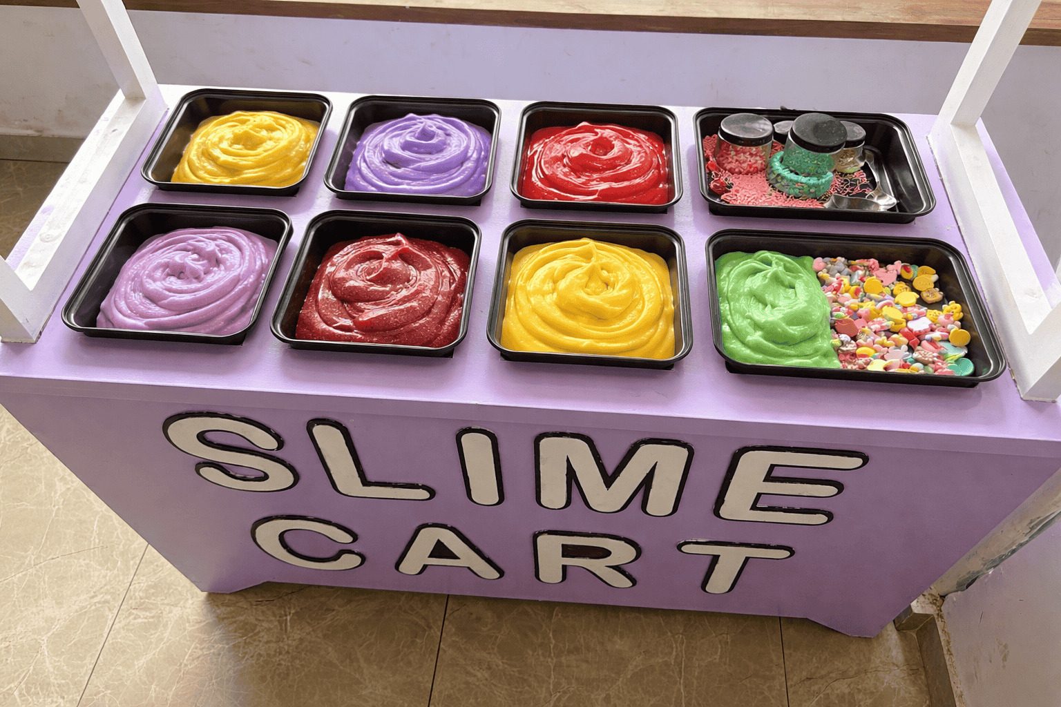 Splashit slime cart loaded with trays of coloured slime